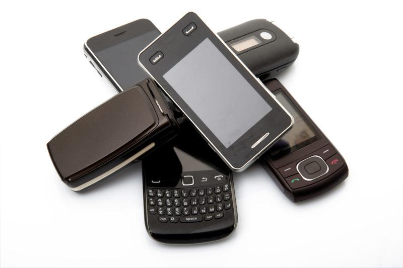 old and obsolete cellphone on white background